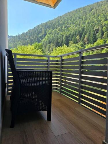 a chair on a balcony with a view of a mountain at Appartamenti a Lases in Albiano