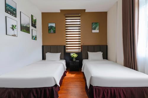 Кровать или кровати в номере Nature Hotel - Luong The Vinh