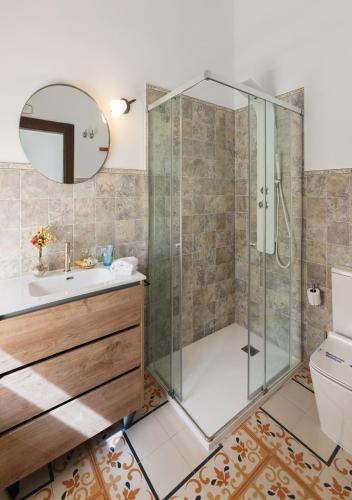 a bathroom with a shower and a sink at Art Boutique La Casona de las Flores in Ondara