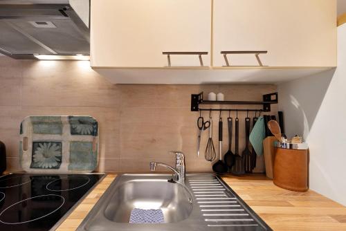 トラフェミュンデにあるFerienwohnung Strandquartierのキッチン(ステンレス製のシンク、調理器具付)