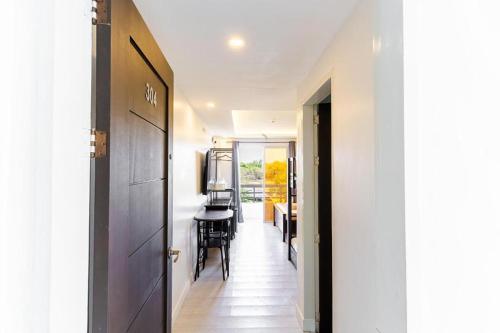 a hallway with a door leading to a dining room at Spotlight Hotel near Hundred Islands Wharf in Alaminos
