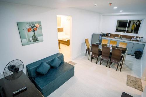 a living room and kitchen with a couch and a table at Spotlight Hotel near Hundred Islands Wharf in Alaminos