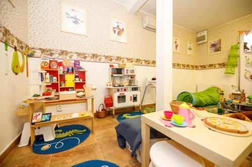 a childs room with a desk and a play area at Penzion Sonáta in Luhačovice