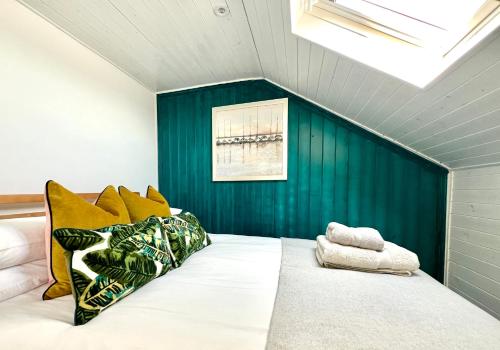 a bedroom with a large bed with a blue wall at Central, Seaview Apartment, 3 beds, 2 baths, kid & dog friendly at The Lookout Broadstairs in Broadstairs