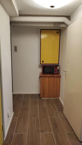 a room with a flat screen tv on a wall at nice apartment in Viby in Sollentuna