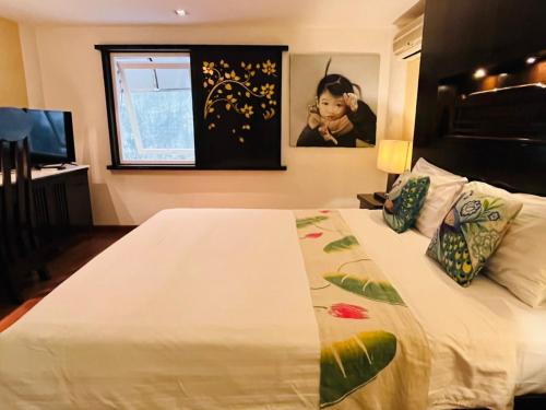 a bedroom with a bed with a white bedspread at Baipho Lifestyle in Patong Beach