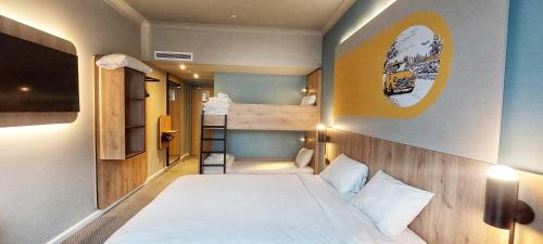 a small bedroom with a bed and a bunk room at B&B HOTEL London Heathrow in Hillingdon