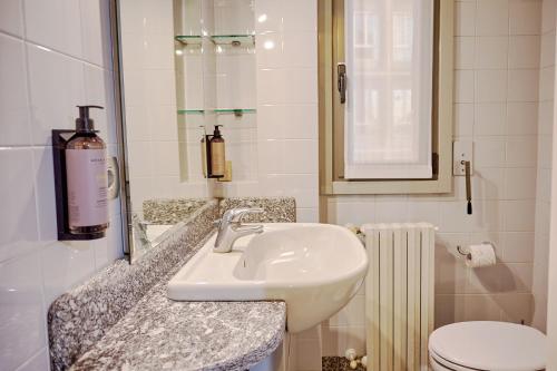a bathroom with a sink and a toilet and a mirror at Milan Retreats in Milan