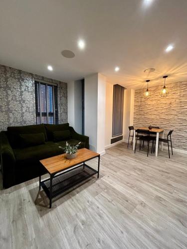 a living room with a couch and a table at Cosy City Centre Location, Hydro Massage Showe in Manchester