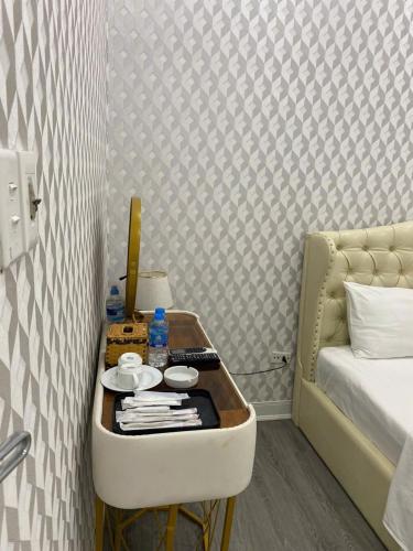 a room with a bed and a table next to a bed at Khách sạn Hướng Dương in Hanoi