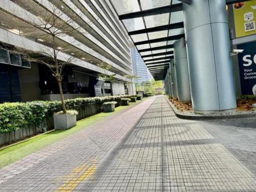 an empty hallway of a building with trees and plants at Mercu Summer Suites Kuala Lumpur Bukit Bintang By Classy in Kuala Lumpur