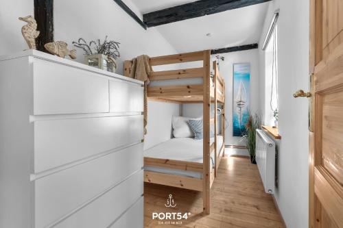a small bedroom with a bunk bed and a desk at Dornröschen 2 in Steinberg