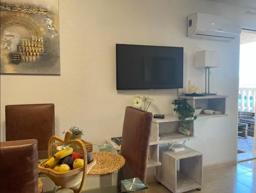 a living room with a table with a bowl of fruit at Casa Luna - Sea view apartment Bolnuevo in Bolnuevo