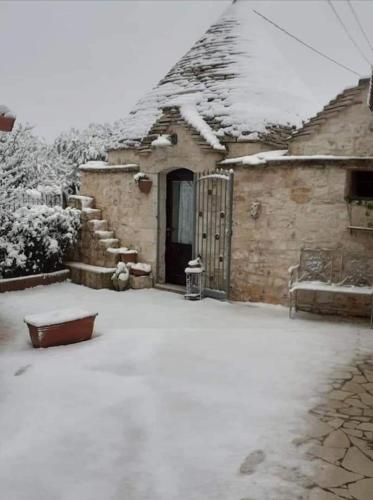 a house with snow on the roof of it at L'Isola Felice e Trulli Sotto Le Stelle in Castellana Grotte