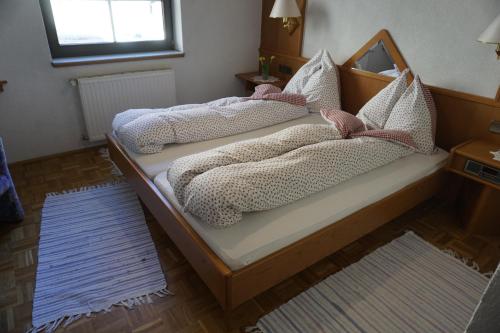 two beds with pillows on them in a bedroom at Gasthof Torwirt in Sankt Lambrecht
