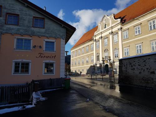 a group of buildings on a city street at Gasthof Torwirt in Sankt Lambrecht