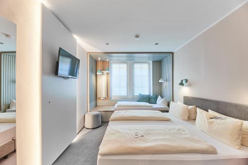 a row of beds in a hotel room at Hotel Weinhof in Cochem