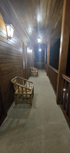 a room with two wooden benches in a building at Moradia Pérola da Natureza in Lemos