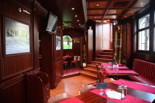 a restaurant with red tables and chairs in a train at Alpin Borovets, Алпин Боровец in Borovets