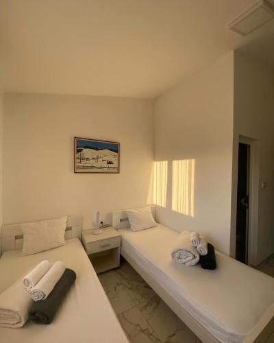 two beds in a room with towels on them at Vila Safir in Loznica