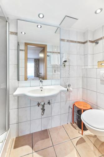 a bathroom with a sink and a mirror at Hotel Weinhof in Cochem