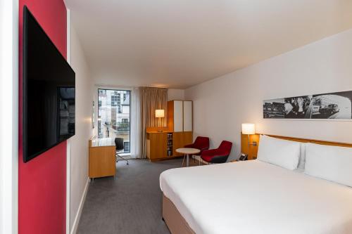 a hotel room with a bed and a tv at DoubleTree by Hilton Hotel London - Tower of London in London