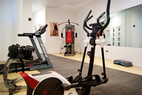 a gym with two exercise bikes and a treadmill at Hotel Andalussia in Conil de la Frontera
