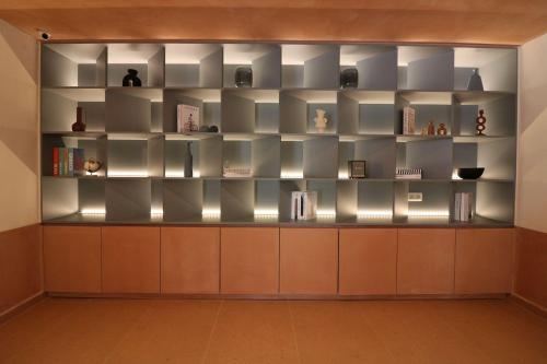 a book shelf in a room with books on it at Philoxenia Apartments in Panormos Rethymno
