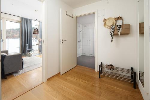 a hallway with a door open to a room with a bench at BJØRVIKA APARTMENTS, Opera Area, Oslo city center in Oslo