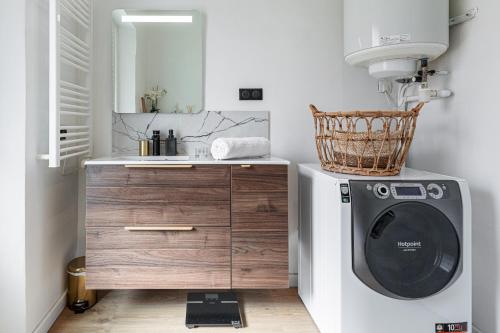 une salle de bain avec une machine à laver et un lavabo dans l'établissement 37 MASSENA LOT 2 - Superbe 3 pieces - Zone Pietonne - A-C, à Nice