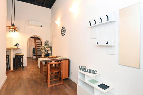 a kitchen and dining room with white cabinets and a table at Il nido di Elisa in Albano Laziale