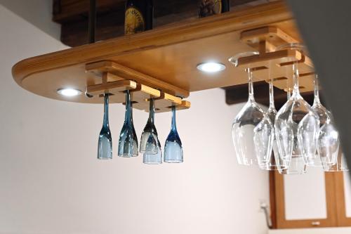 a bunch of wine glasses hanging from a chandelier at Il nido di Elisa in Albano Laziale