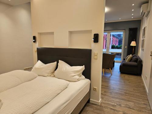 a bedroom with a bed and a living room at Appartement Vermietung Brunner in Rostock