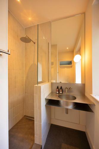 a bathroom with a sink and a shower at Finest Retreats - ARC Peaks in Allgreave
