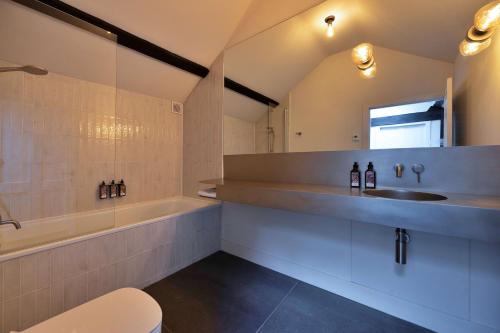 a bathroom with a sink and a bath tub at Finest Retreats - ARC Peaks in Allgreave
