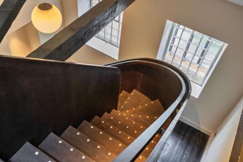 a spiral staircase in a building with a window at Finest Retreats - ARC Peaks in Allgreave