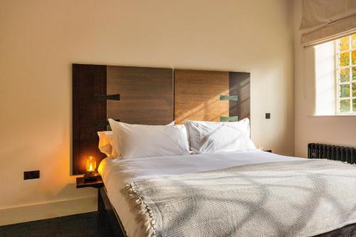 a bedroom with a large bed with white pillows at Finest Retreats - ARC Peaks in Allgreave