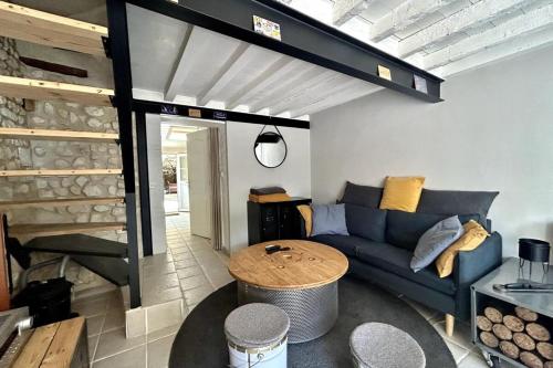 un salon avec un canapé bleu et une table dans l'établissement Le Saint-Ouen charmante maison tout confort !, à Les Authieux-sur-le-Port-Saint-Ouen