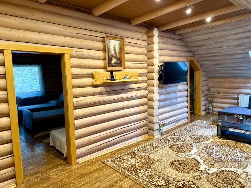 a log cabin with a living room with a couch at Апартаменти з 2 спальними кімнатами in Mukacheve