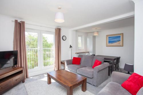 a living room with a couch and a table at 3 Bedroom Duplex with Free Parking in Glasgow