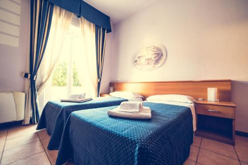 En eller flere senge i et værelse på Hotel La Gaietta