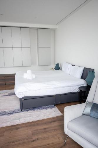 a bedroom with a large bed and a couch at Stunning 3 Bed Penthouse in West End in Glasgow