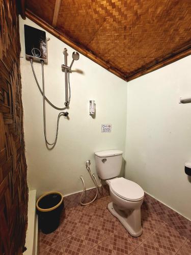 a bathroom with a toilet and a shower at Breizh Cape Beach Bungalows in Ko Lanta