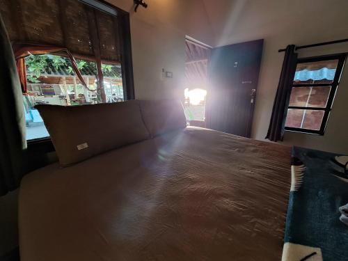 a large bed in a room with a window at Breizh Cape Beach Bungalows in Ko Lanta