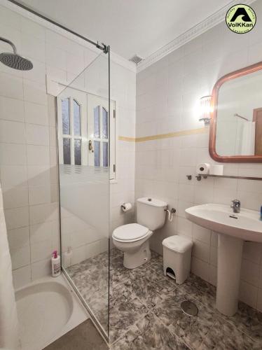 a bathroom with a toilet and a sink and a shower at VolKKanrentals Beach View House in Famara