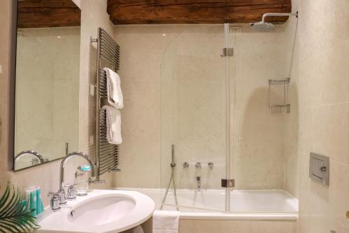 a bathroom with a shower and a sink and a tub at Al Redentore Di Venezia in Venice