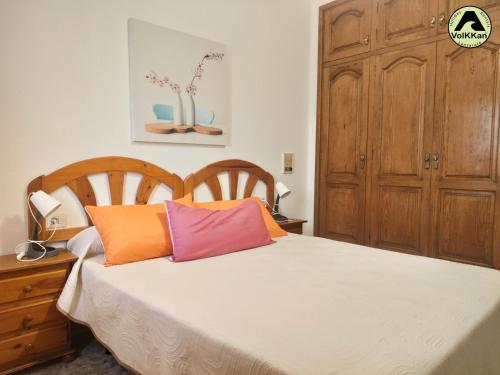 a bedroom with a bed and a wooden cabinet at VolKKanrentals Beach View House in Famara