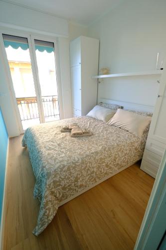 a bedroom with a bed with two shoes on it at Perla Blu by PortofinoVacanze in Rapallo