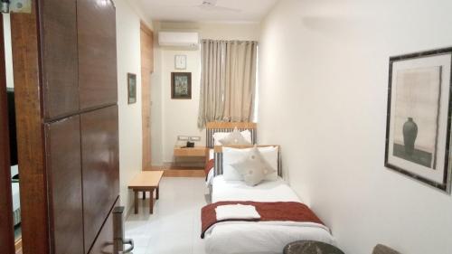 a small room with a bed and a table at Bentley Hotel Marine Drive in Mumbai