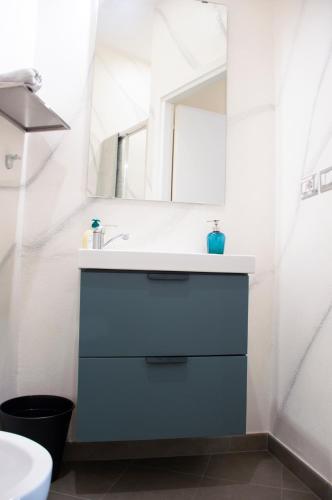 a bathroom with a sink and a mirror at Luxury Suite Station in Barletta
